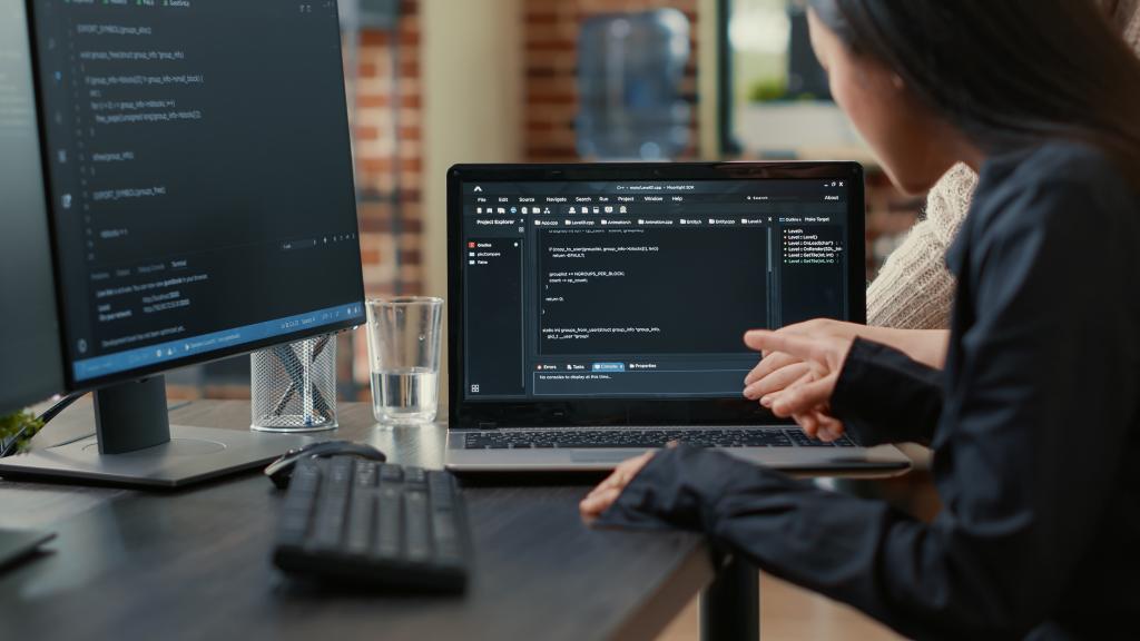 team-of-programmers-talking-about-algorithm-running-on-laptop-screen-pointing-at-source-code-while-sitting-at-desk-software-developers-collaborating-on-data-coding-group-project (1).jpg